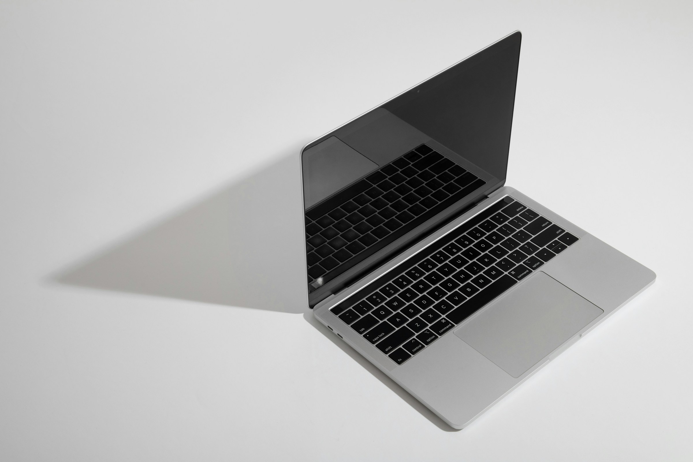 Silver 14-inch MacBook Pro, open, three-quarter view